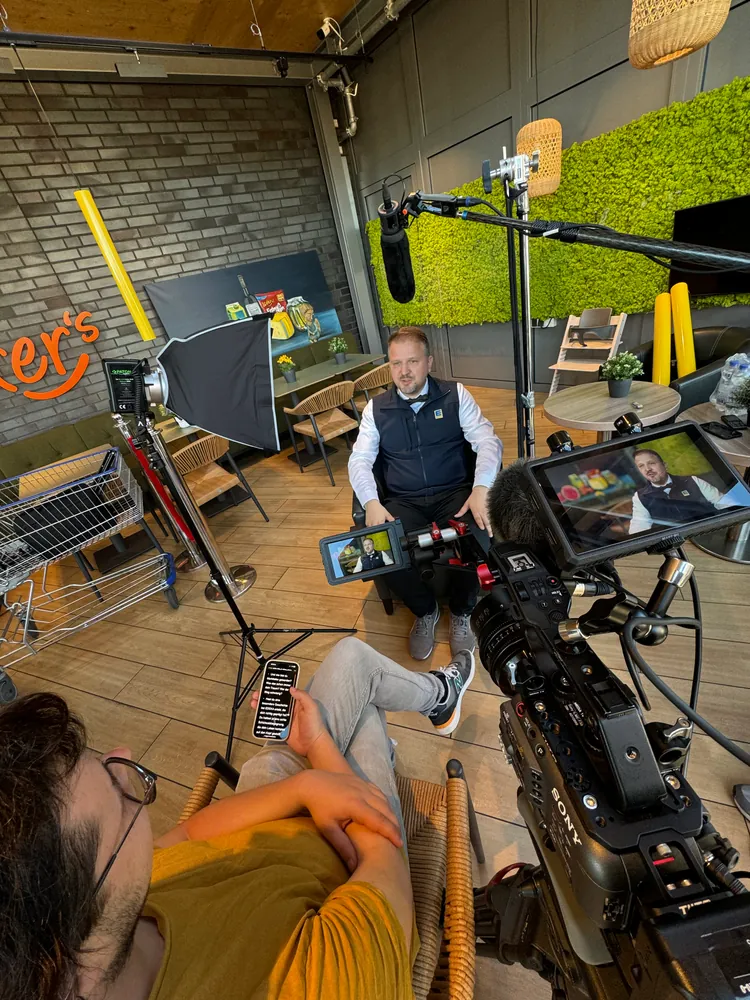Interviewdreh in einem Café: Kamera mit Kontrollmonitor, Softbox-Leuchte und Richtmikrofon